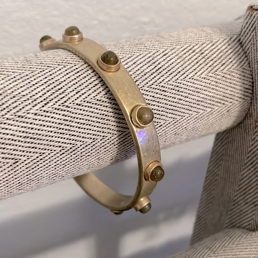 Gold colored bangle.